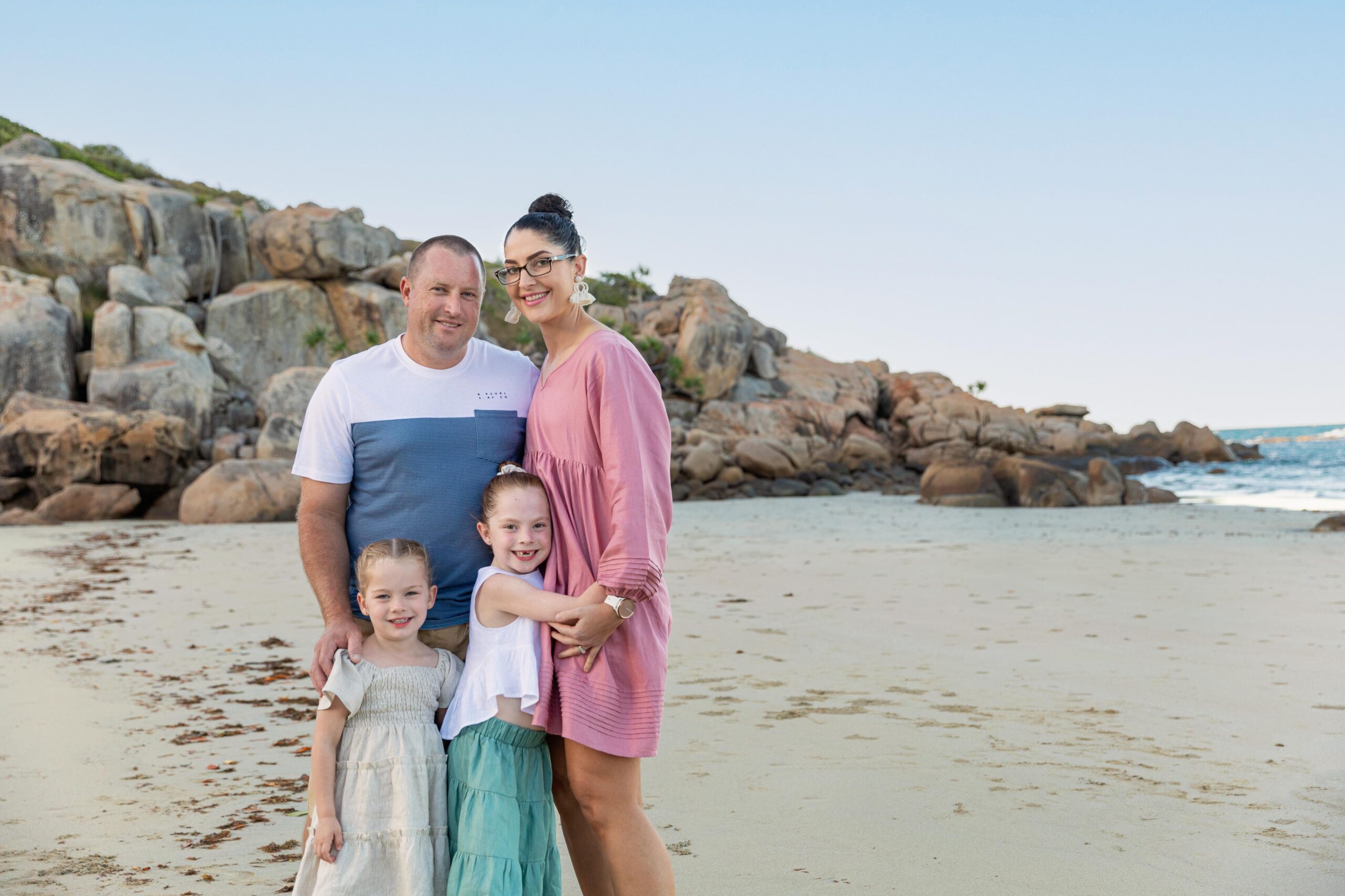 Mum, Dad and their two girls are Rose Bay at Sunset for a family photo session